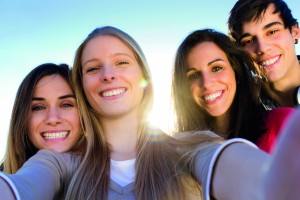 A group of friends taking photos with a smartphone