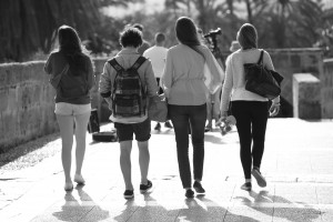 Rear view of four students walking away